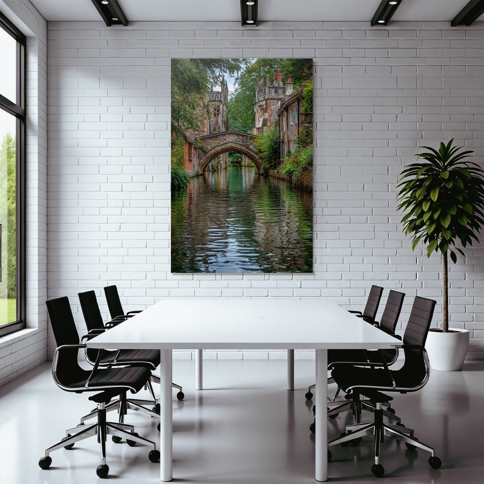 Stone bridge over a tranquil watercourse with green banks and historic buildings
