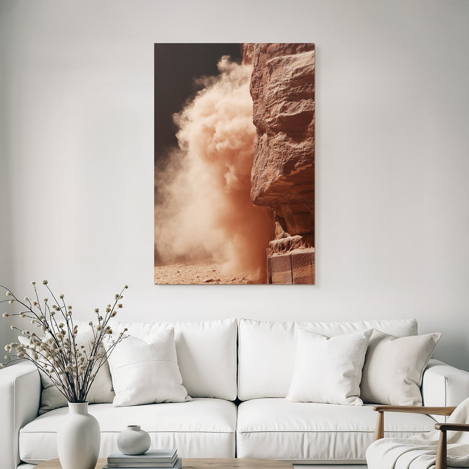 Dust cloud in desert next to rock formation