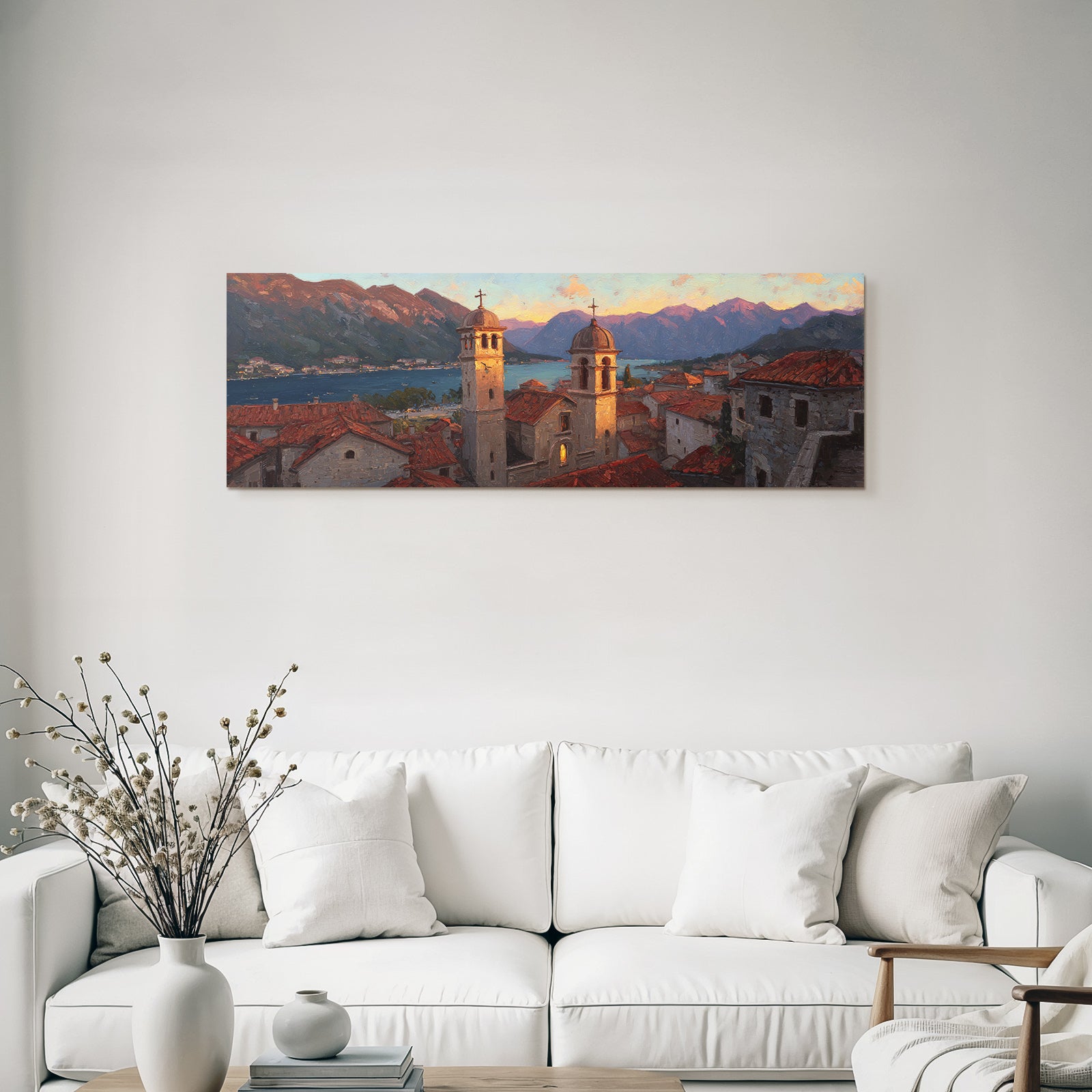 Sunset in Mediterranean coastal town with terracotta roofs and mountains