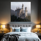 Large ornate castle on a rocky outcrop surrounded by trees and mountains