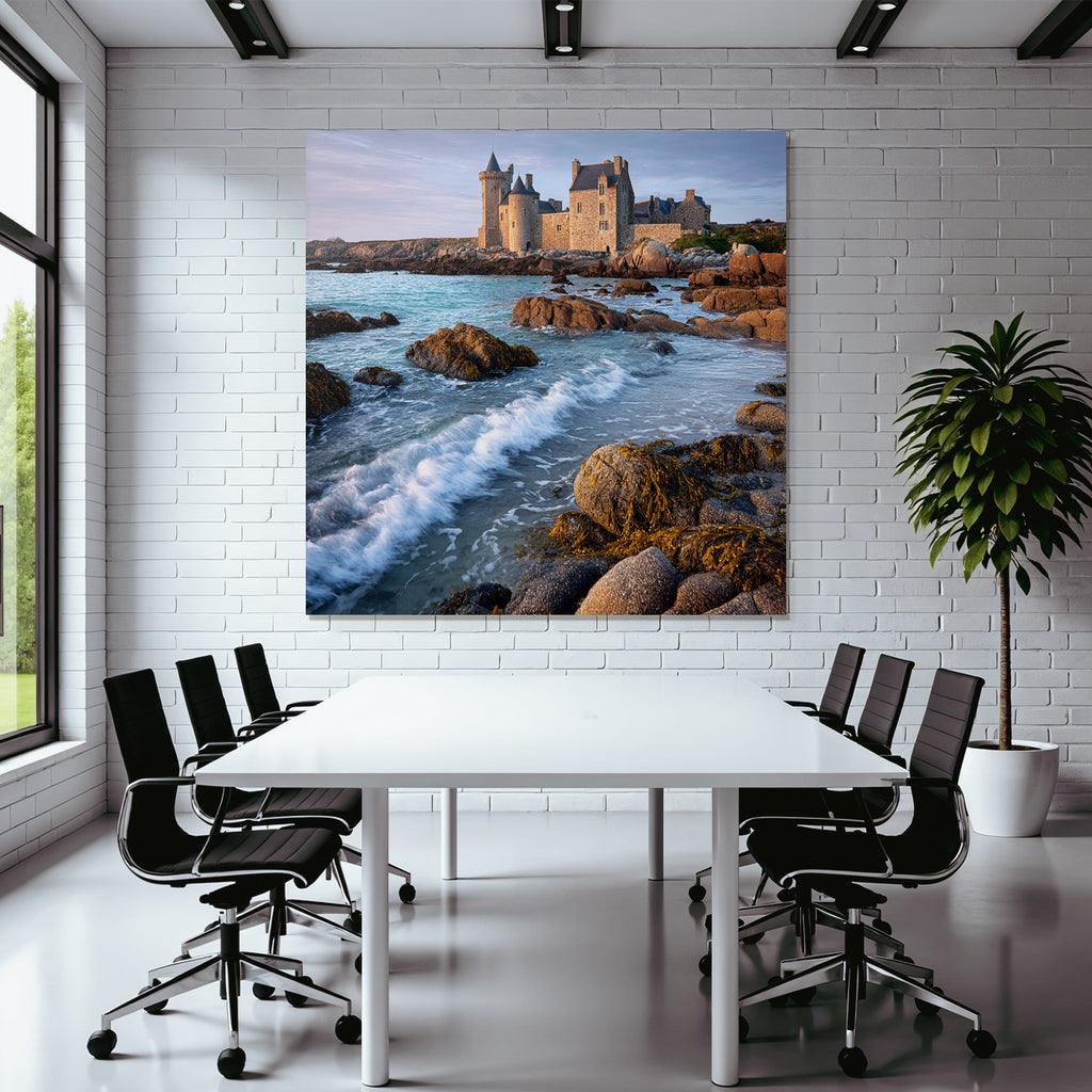 Coastal stone building with towers and calming wash on the horizon