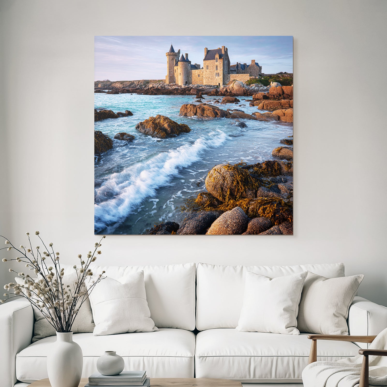 Coastal stone building with towers and calming wash on the horizon