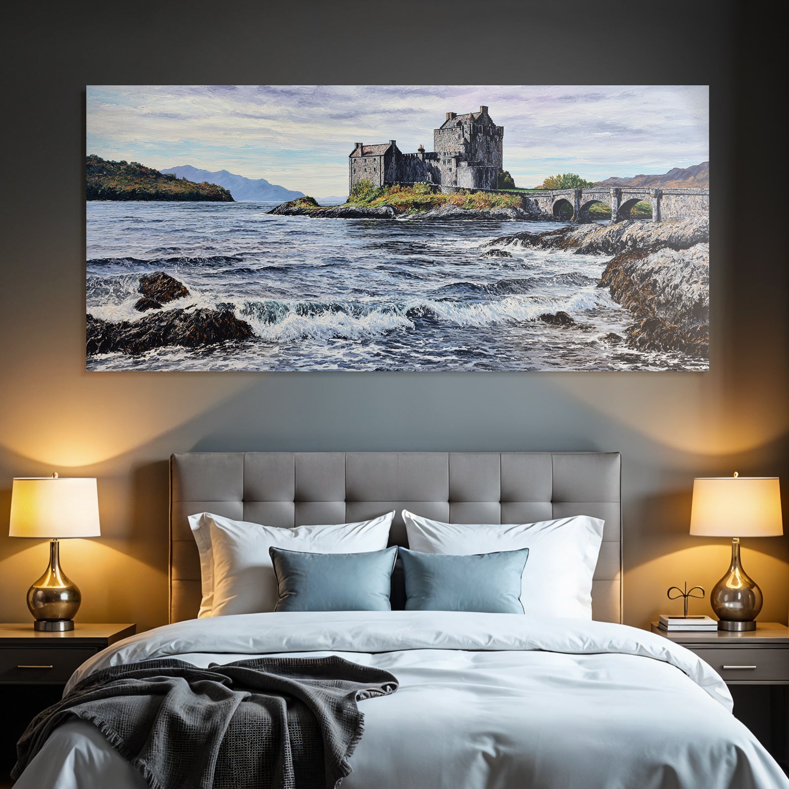 Castle on rock by the sea with bridge and mountains in the background