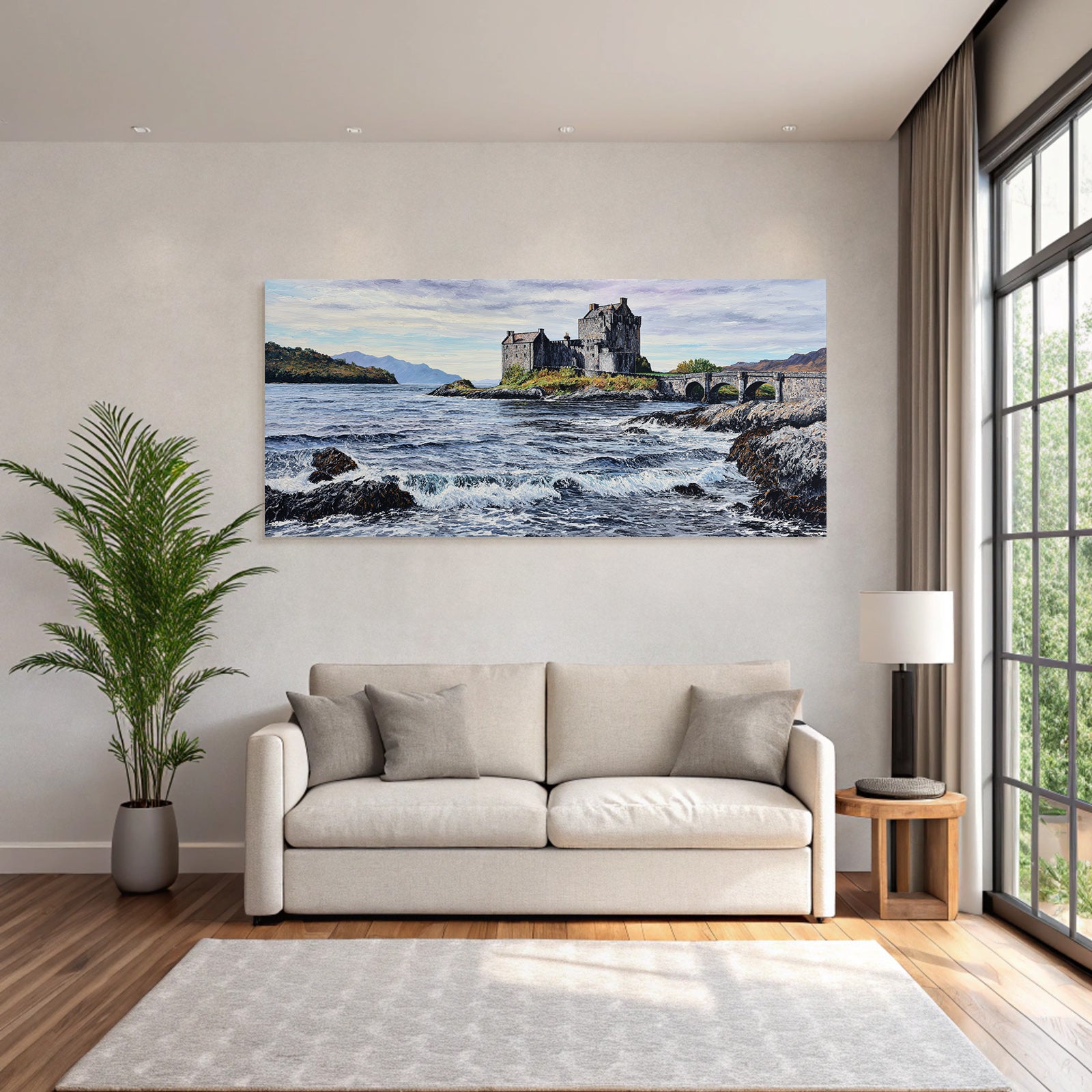 Castle on rock by the sea with bridge and mountains in the background