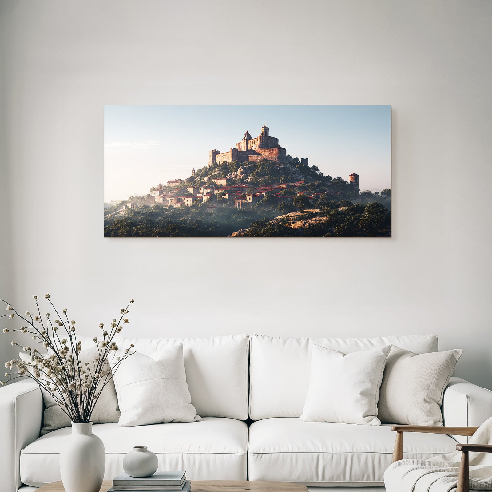 Medieval castle on a hill surrounded by greenery and village