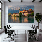 Scenic Riverside View With Red Tiled Roofs And Snow Capped Mountains
