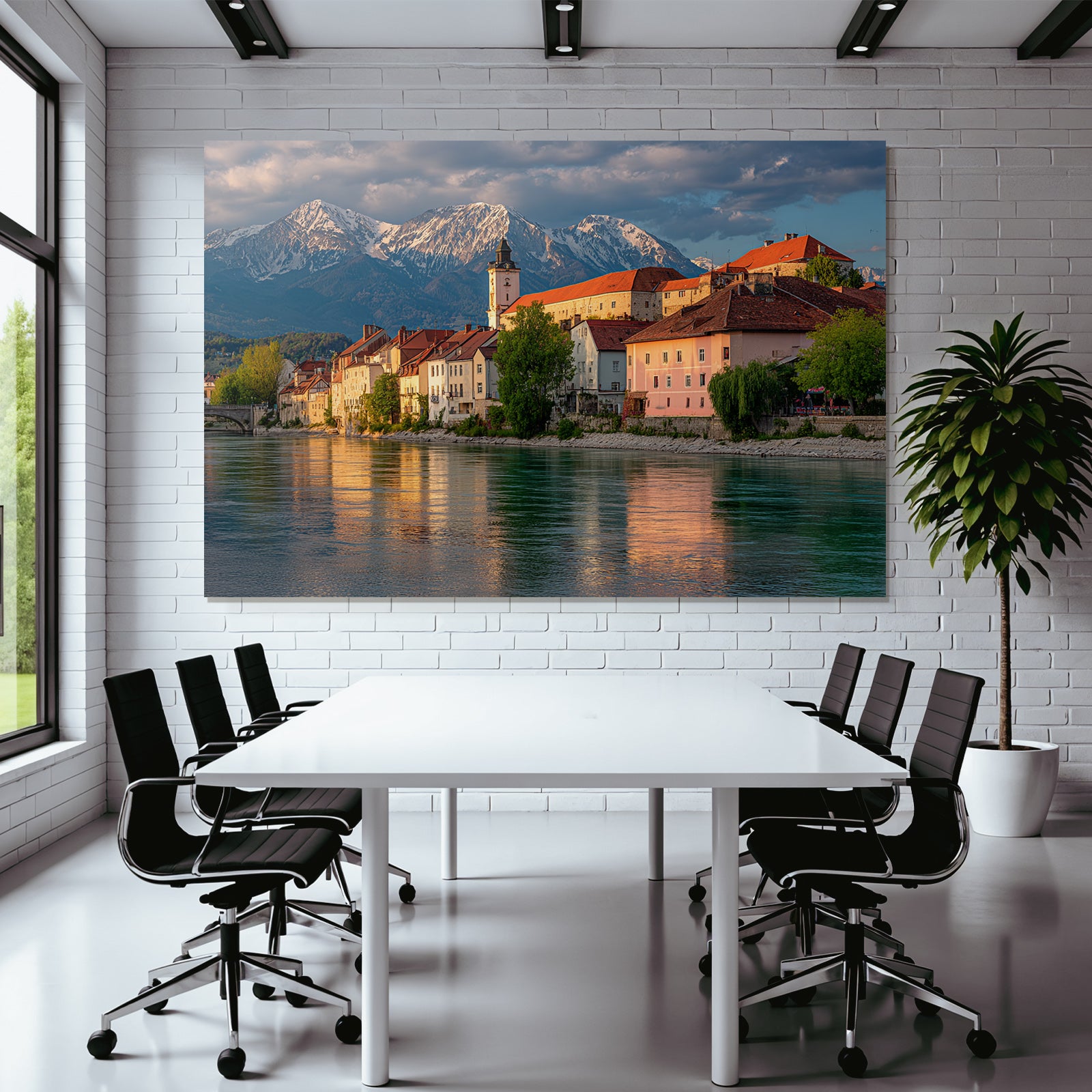Scenic Riverside View With Red Tiled Roofs And Snow Capped Mountains