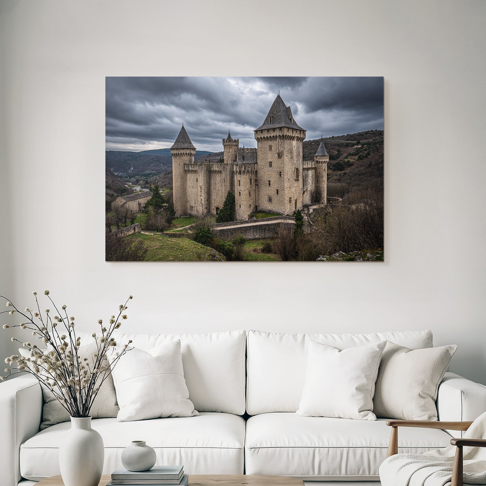 Castle in the mountains with trees under a cloudy sky