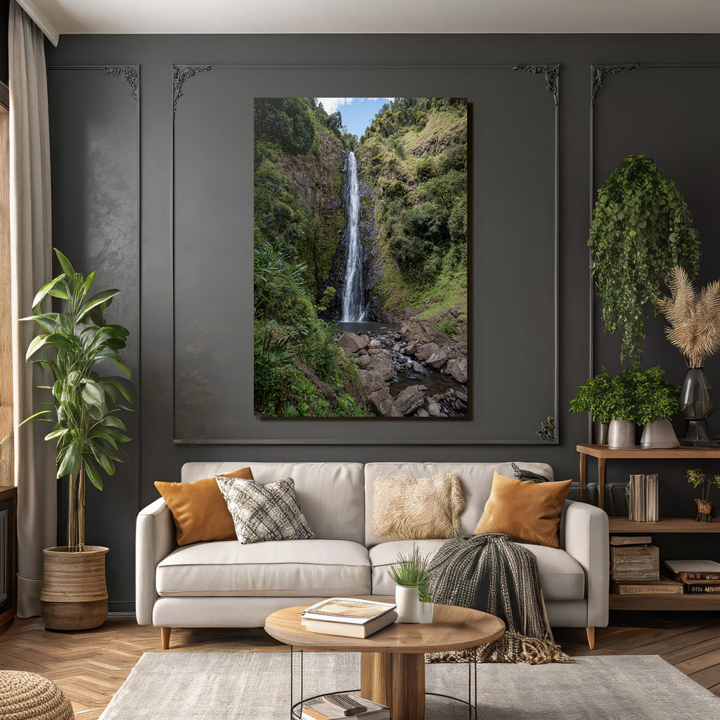 Tropical and jungle waterfall surrounded by green terrain and clear skies