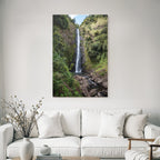 Tropical and jungle waterfall surrounded by green terrain and clear skies
