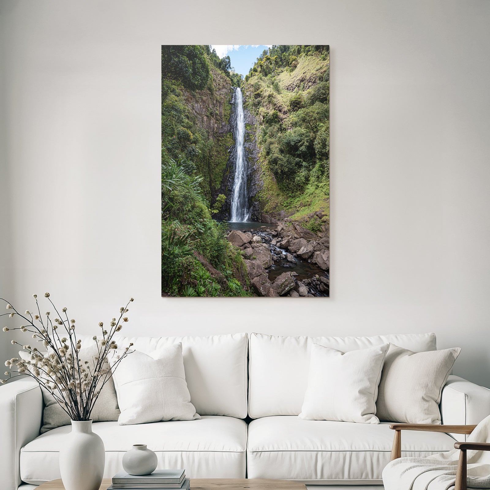 Tropical and jungle waterfall surrounded by green terrain and clear skies