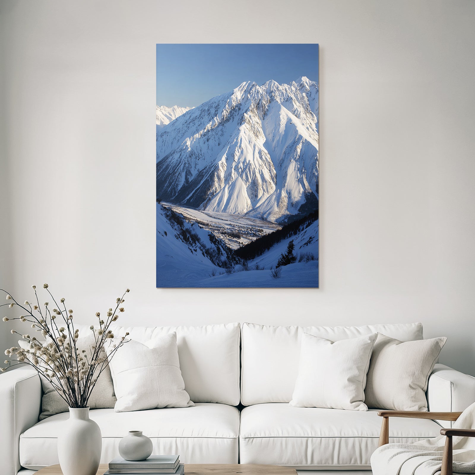 Winter snow-covered mountain landscape with valley and village in the foreground
