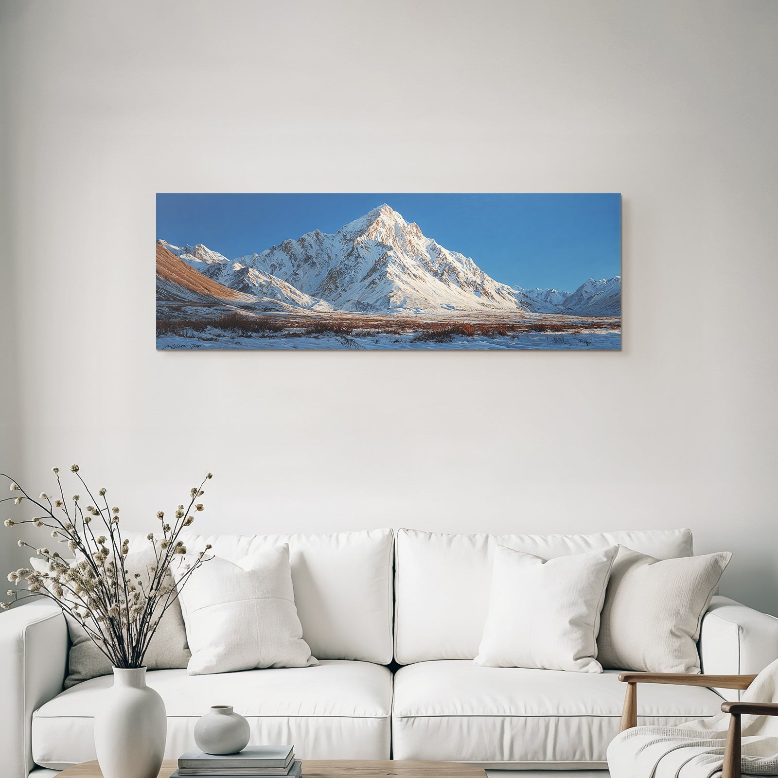 Winter mountain landscape with snow-capped peaks and blue sky