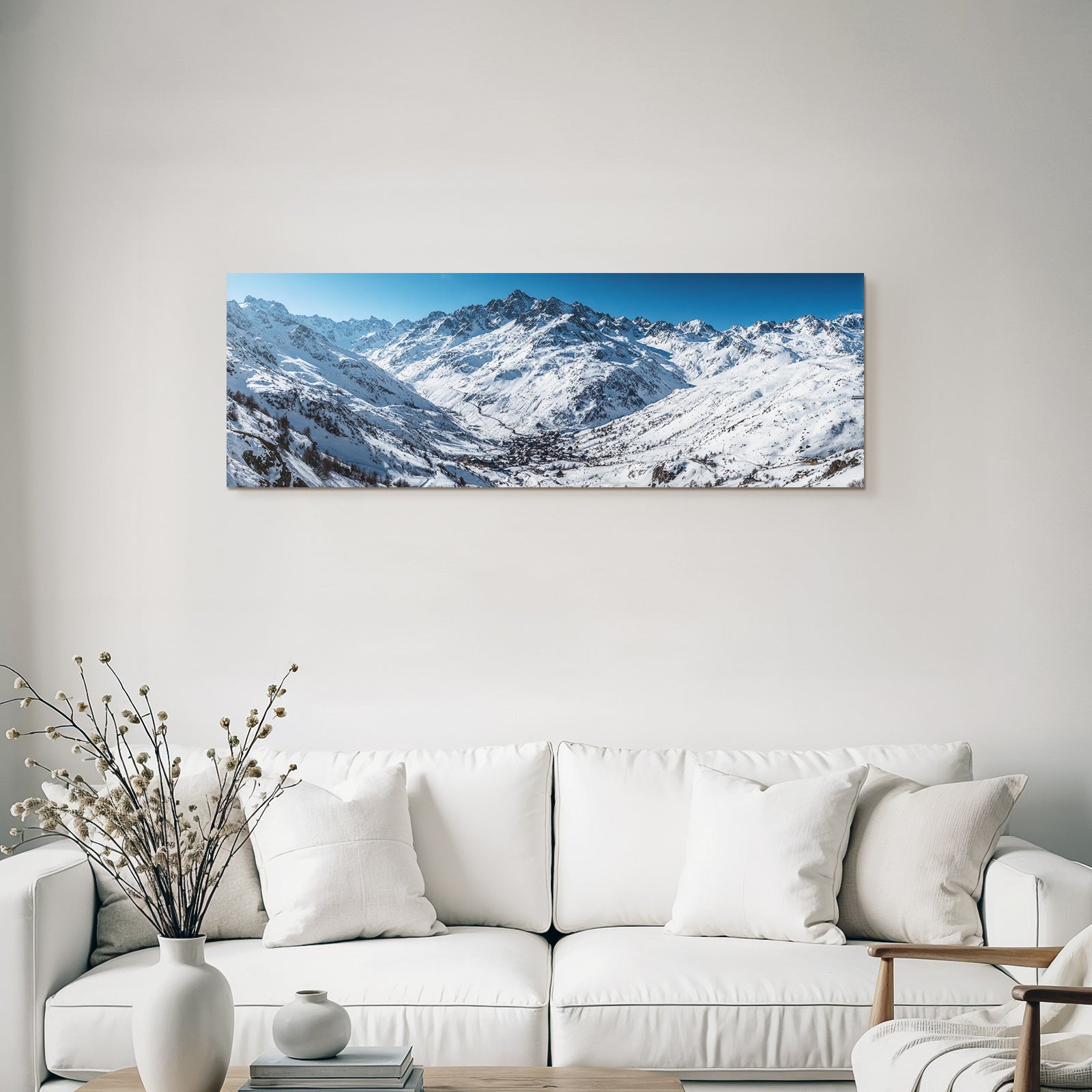 Winter snow-covered mountain landscape with village under blue sky