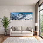 Winter snow-covered mountain landscape with village under blue sky