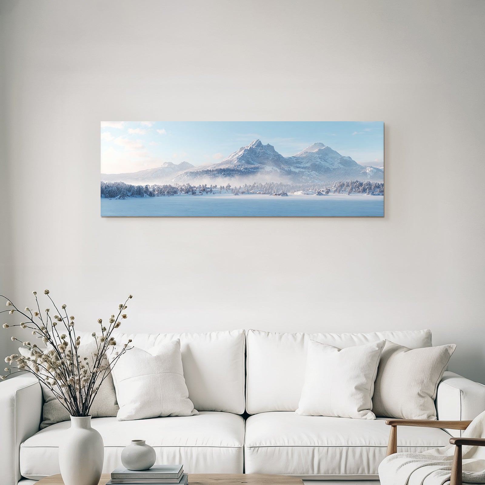 Winter landscape with snow-capped mountains and forest under blue sky