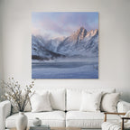 Winter tranquil winter landscape with snow-capped mountains and frozen lake