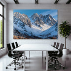 Winter mountain landscape with snow-capped peaks and blue sky