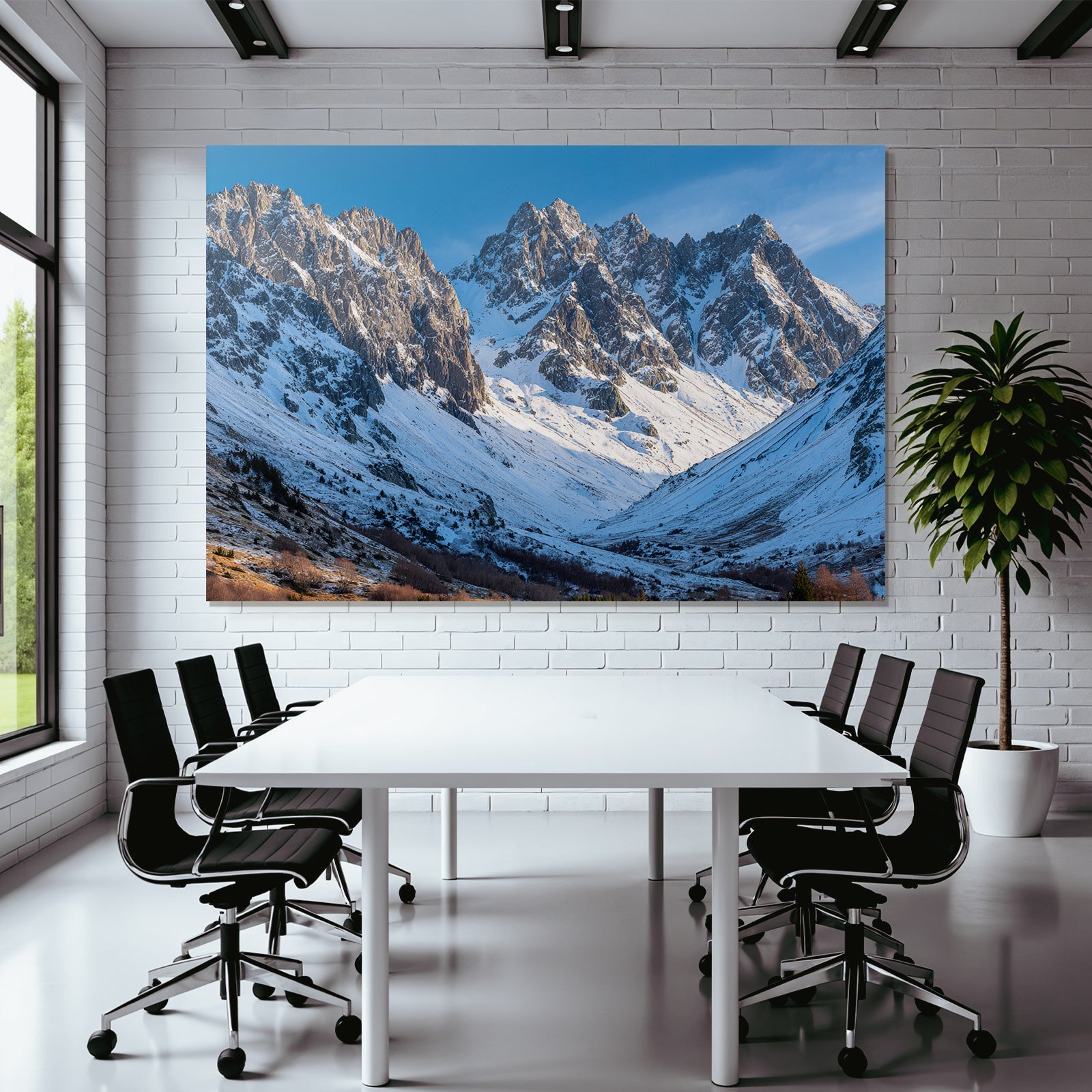 Winter mountain landscape with snow-capped peaks and blue sky