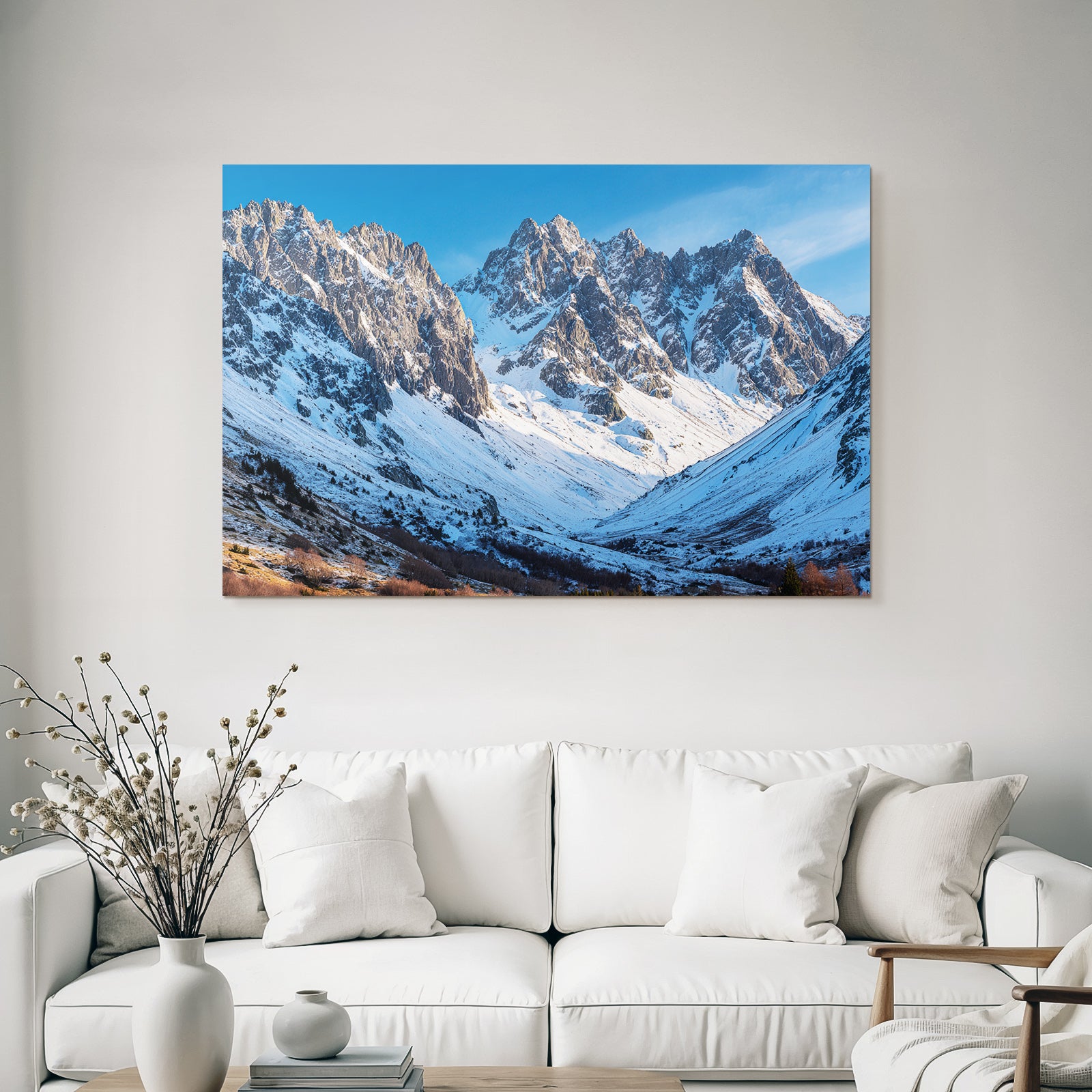 Winter mountain landscape with snow-capped peaks and blue sky