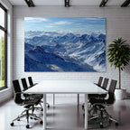 Winter snow-covered mountains under blue sky with clouds