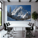 Winter snow-covered mountain peak with wooded winter landscape snow path
