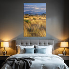 Desert golden grassland with acacia trees and mountains under cloudy sky