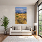 Desert golden grassland with acacia trees and mountains under cloudy sky