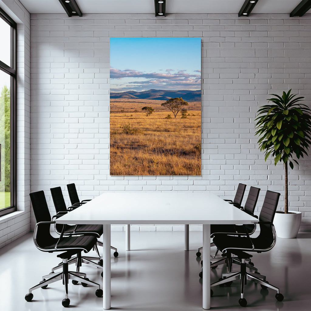 Desert golden grass landscape with trees and hills under blue sky