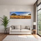Desert panoramic view of savannah with golden grasslands and blue skies