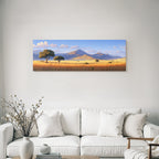 Desert tranquil landscape with mountains, hills and fields with golden grass under blue sky