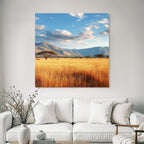 Desert tranquil natural landscape with hills and golden grass under partly cloudy sky