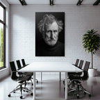 Portrait of an older man with messy hair and a serious expression