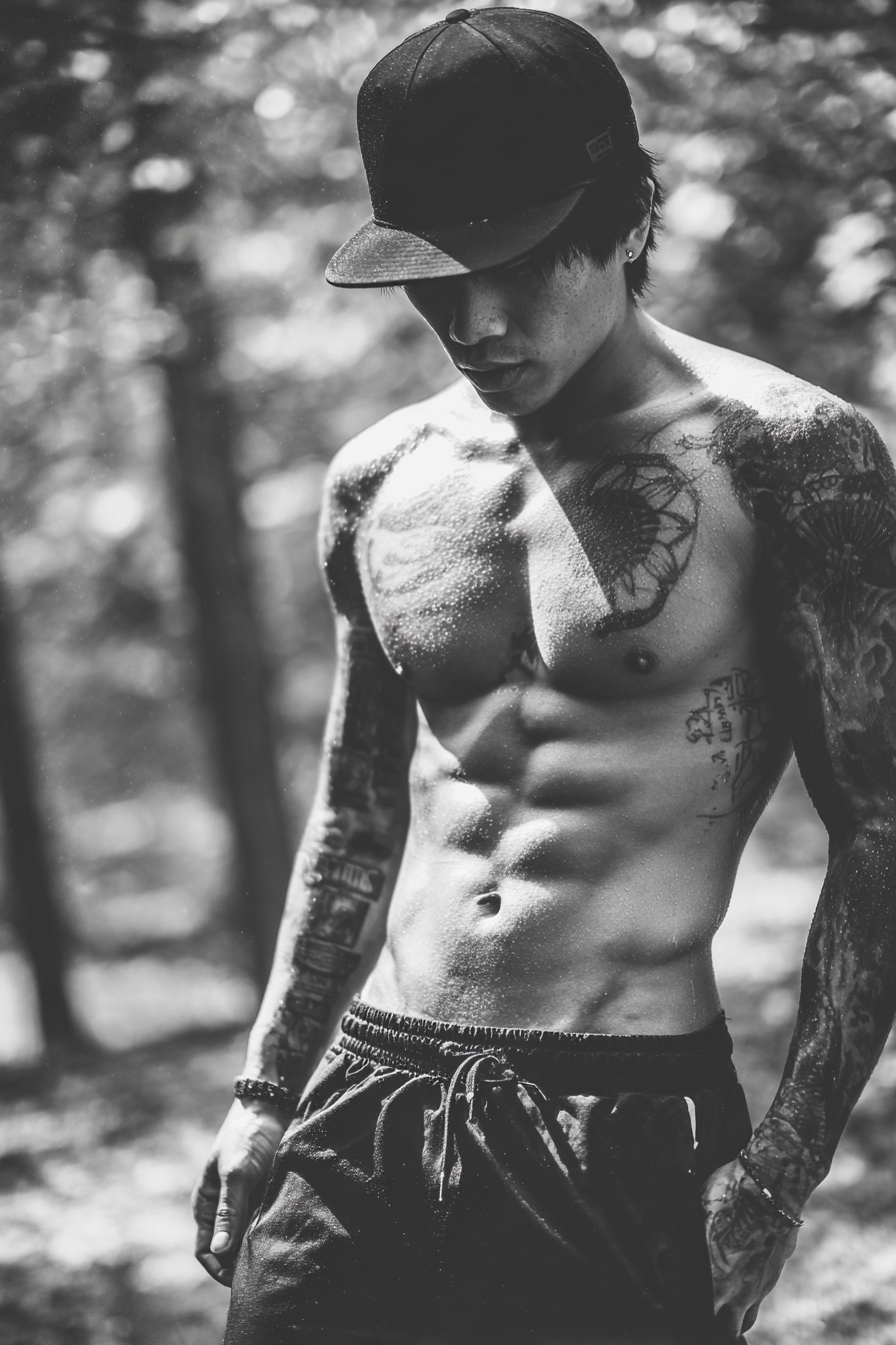 Muskelphysiqü Mit Tattoos Im Naturhintergrund Bei Ernster Betrachtung | Mode und Stil | Menschen und Emotionen
