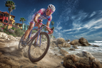 Fahrradfahrer Am Strand Mit Palmbaeumen Und Kunterbunten Gebaeuden | Sport und Bewegung | Themen und Hobbys