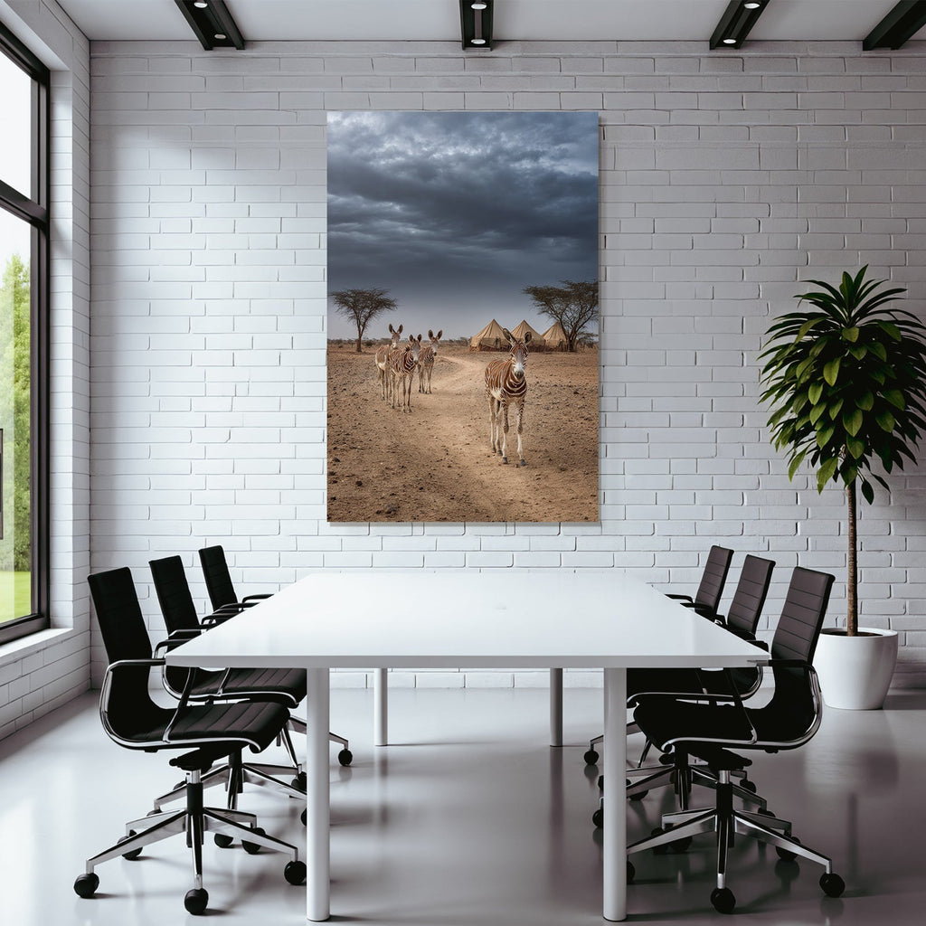 Zebras on the dusty path with tent camp and dramatic sky