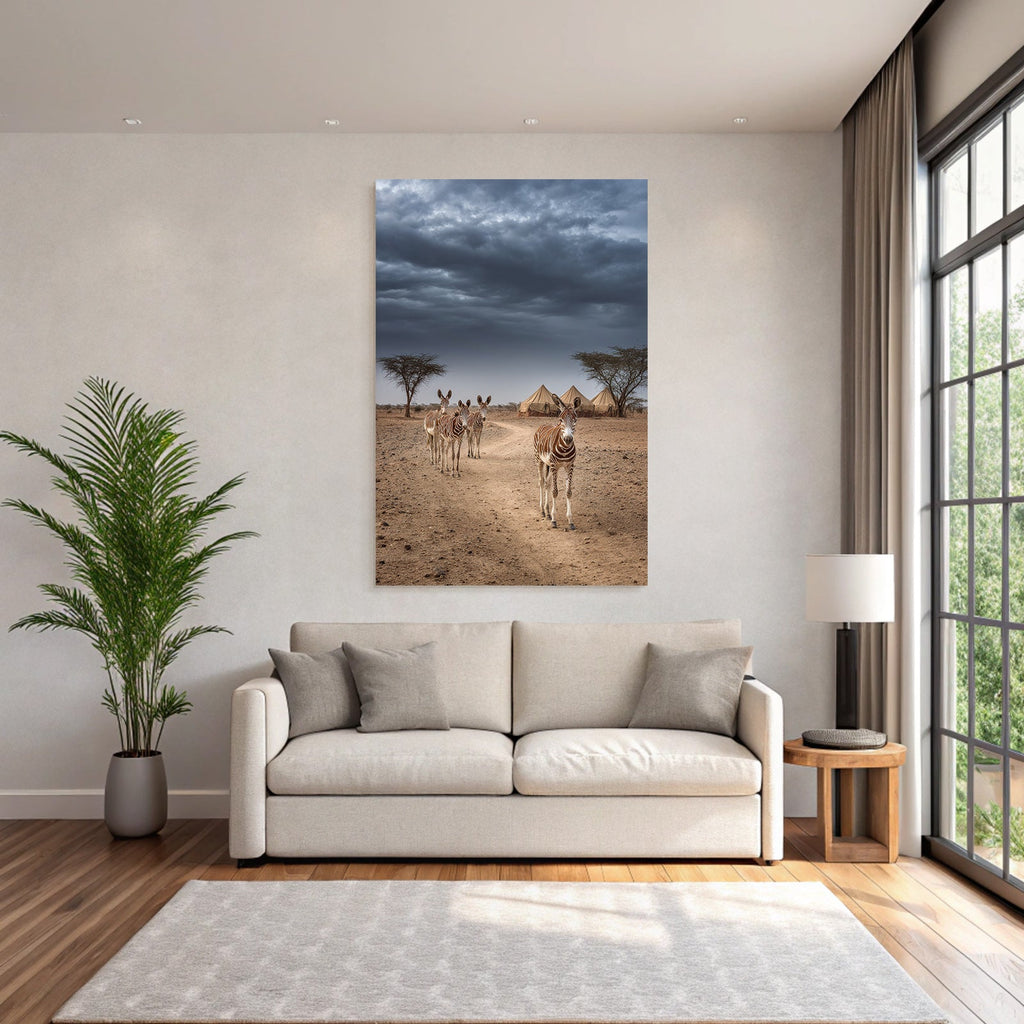 Zebras on the dusty path with tent camp and dramatic sky